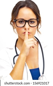 Pretty medical doctor woman commanding silence with glasses and stethoscope over white background