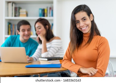 Pretty Mexican Female Student With Group Of Computer Science Students At Classroom Of University