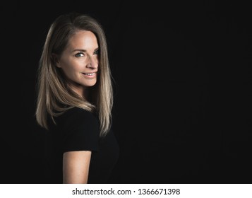 Pretty Middle Aged Blonde Woman On Black Background. 