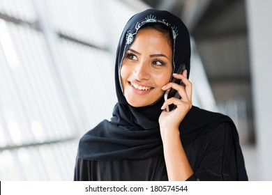 pretty middle eastern woman talking on mobile phone - Powered by Shutterstock