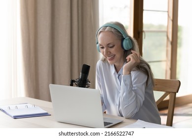 Pretty Middle-aged Woman Sit At Desk With Laptop Talk To Online Audience, Speaks Into Mike. Take Part In Livestream Event, Records Podcast. Broadcast On Air, Hosting, Blogging, Presenting News Concept