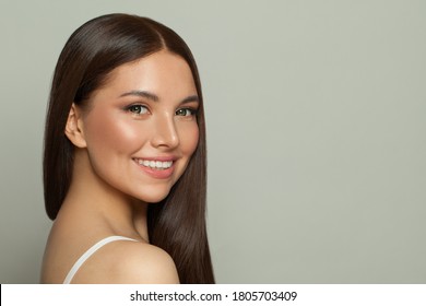 Pretty model woman with clear skin and long healthy straight hair. Skincare and facial treatment concept