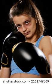 Pretty Muay Thai Female Boxer With Bruise On Face In Attack Pose. Fitness Young Woman Boxing Training On Black Background, Closeup