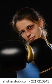 Pretty Muay Thai Female Boxer With Bruise On Face In Attack Pose. Fitness Young Woman Boxing Training On Black Background, Smiling