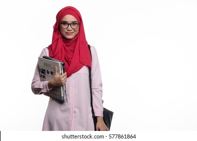 Pretty muslim female student with hijab is carrying books and a slingbag isolated on white background - Powered by Shutterstock