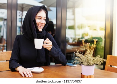 Pretty Muslim Woman Having Coffee In A Cafe