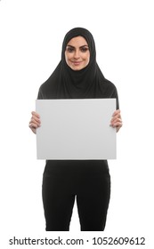 Pretty Muslim Woman Holding A Blank Poster, Staring And Smiling. Place Your Text Or Picture Here.