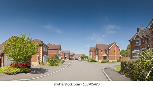 Pretty newly built homes and gardens against a clear blue summers sky. Stitched panoramic image detailed when viewed large.