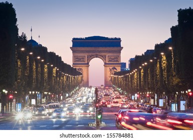 Pretty night time illuminations of the Impressive Arc de Triomphe (1833) along the famous tree lined Avenue des Champs-Elysees in Paris.