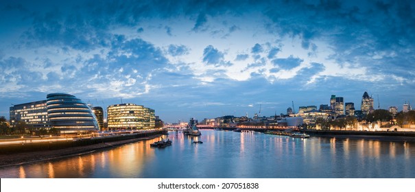 Pretty Nighttime Illuminations Of The River Thames, Many Sights Visible Including London City Hall, HMS Belfast, Tower Of London And The Cities Financial District.