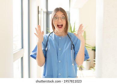 Pretty Nurse Feeling Happy, Excited, Surprised Or Shocked, Smiling And Astonished At Something Unbelievable