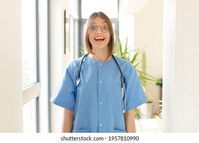 Pretty Nurse Looking Happy And Pleasantly Surprised, Excited With A Fascinated And Shocked Expression