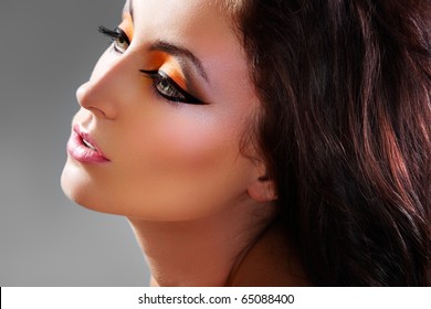 Pretty oriental look. Sensual brunette model. Close-up portrait of arabic woman. Creativity bright make-up & long volume dark hair.
