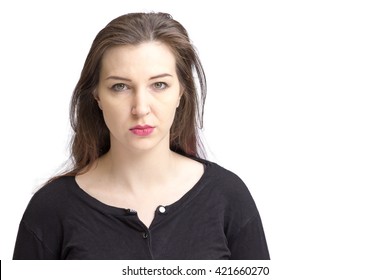 Pretty Pale Woman With Dark Hair And Green Eyes. Isolated On A White Background, Looking At Camera Not Smiling.