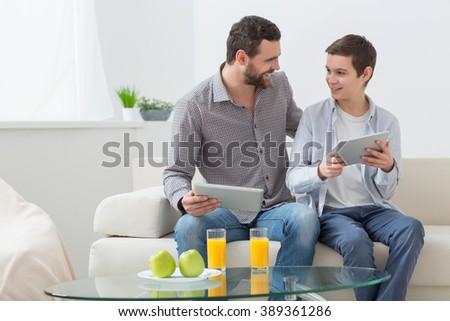Pretty parent and child are using modern technology