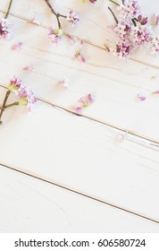 Pretty Pink Small Daphne Flowers On Distressed White Shiplap Board Background With Room Or Space For Copy, Text, Your Words.  It's A Soft And Airy, Vertical Flat-lay Photo With A Top Down View.