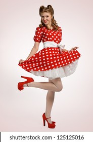 pretty pinup model in a red and white polka-dot dress