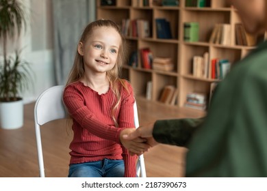 Pretty preschooler girl visiting psychotherapist, woman and child shaking hands, greeting with other before session in office, female kid smiling at psychologist - Shutterstock ID 2187390673
