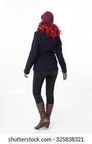 Pretty Red Haired Girl Wearing Winter Coat, Purple Woolen Hat And Scarf, Back Towards Camera.  Rear View. Isolated On White Background.