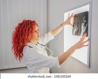 Pretty Redhead Radiologist Reading X Ray Results.