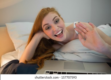 Pretty Redhead Waving To Laptop On Video Chat At Home In Her Bedroom