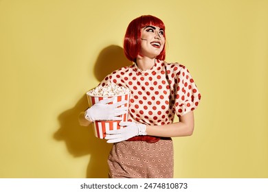 A pretty redhead woman with pop art makeup and white gloves holding a cup of popcorn, dressed in a polka dot blouse. - Powered by Shutterstock