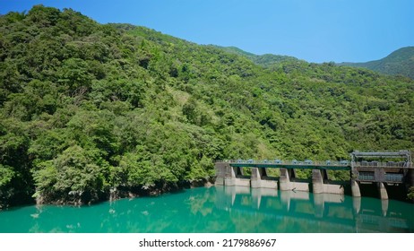 Pretty Scenery Of River And Mountain There Is A Bridge On Right Side