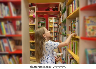  Pretty School Girl In Library Choosing Books. 