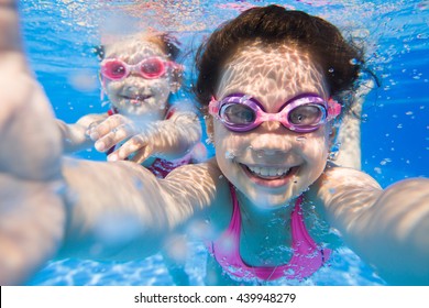 Pretty selfie  two little girls under the water. - Powered by Shutterstock