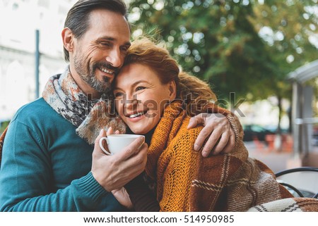 Pretty senior lovers hugging with joy
