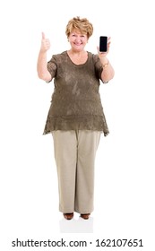 pretty senior woman holding smart phone and giving thumb up isolated on white 