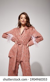 Pretty Sexy Woman Beautiful Face Natural Makeup Brunette Hair Wear Silk Textile Suit Pants And Blouse With Feathers Comfort Casual Home Dress Luxury Lifestyle Pajama Party Glamour Fashion Model.