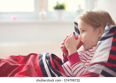 Pretty Sick Little Child Girl Laying In Bed And Drink Tea 