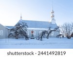 Pretty side view of the 1811 Saint-André catholic church seen in winter on route 132, Saint-André-de-Kamouraska, Quebec, Canada
