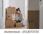 Pretty single young woman tired of carrying moving boxes in her new house, rent apartment home purchase