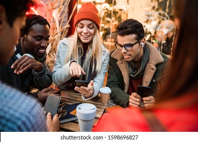 Pretty Smiling Lady Showing Something On The Phone Screen To Her Friends Stock Photo