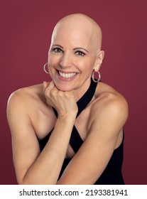 Pretty Smiling Middle Aged Over 50 Woman Survivor With Alopecia Isolated On Red Background