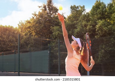 Pretty sportswoman with racquet at the tennis court. Healthy lifestyle - Powered by Shutterstock