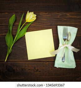 Pretty Spring Table Place Setting With Yellow Tulip, Silverware, Cloth Napkin And A Blank Green Menu Card With Room Or Space For Copy, Text Or Your Words.  