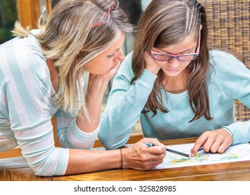 pretty student girl taking courses with beautiful blond teacher