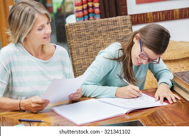 pretty student girl taking tutoring courses with beautiful blond teacher