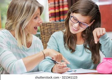 pretty student girl taking tutoring courses with beautiful blond teacher