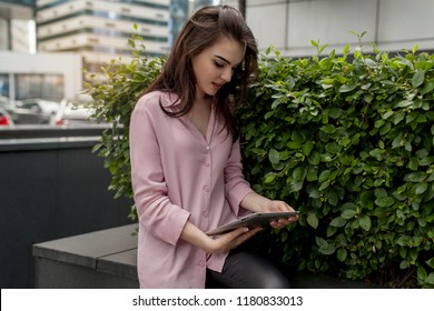 Pretty Student Reading A Pdf Textbook On Digital Tablet And Preparing For A Test. Young Manager Watching Video News On Digital Tablet In Front Of Her Office. Concept Of Wireless Network And Internet
