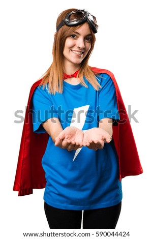 Pretty superhero girl holding something
