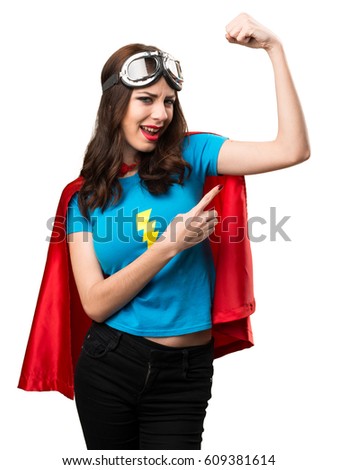 Pretty superhero girl making strong gesture