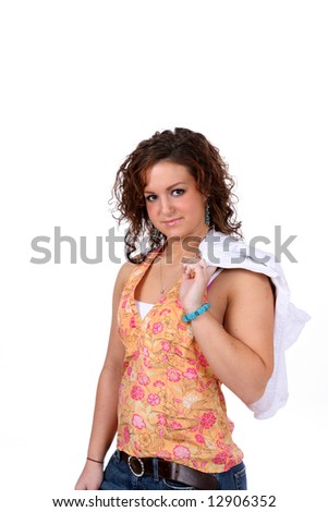 Pretty teen with her jacket slung over one shoulder; against high key background.