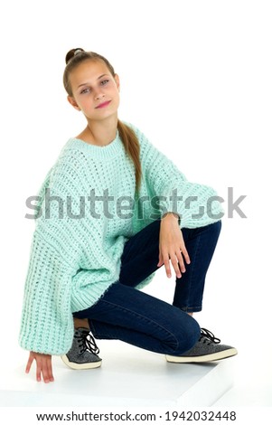 Pretty teenage girl crouched down on her knee