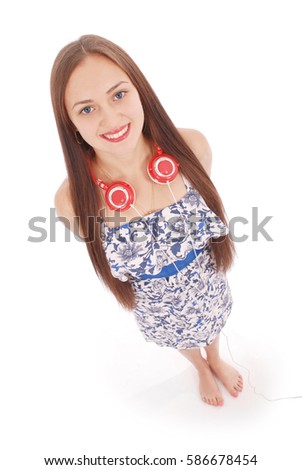 Pretty teenage girl listening music on her headphones isolated on white background