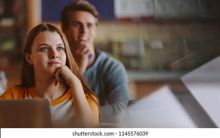 Pretty Teenage Student Paying Attention To Lecture In Classroom. Woman Studying At The College Classroom.