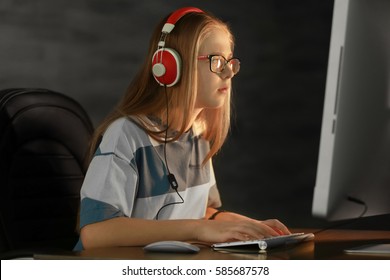 Pretty Teenager Playing Computer Game At Home